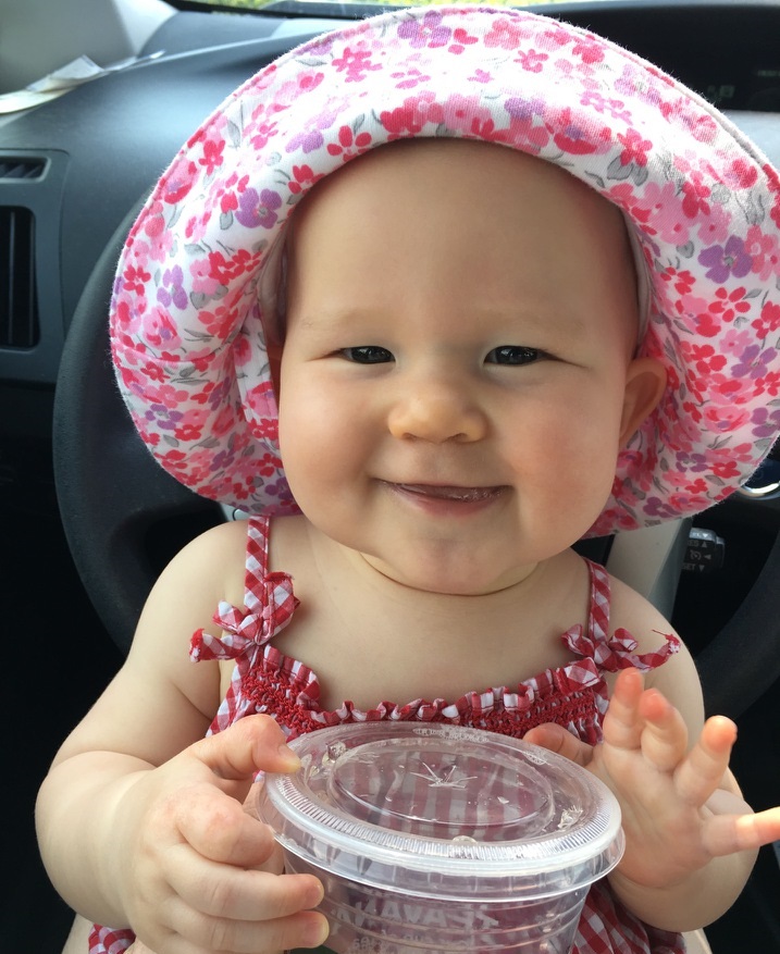 baby girl in a floral bonnet