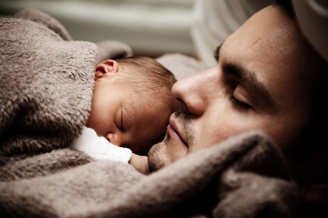 father and baby sleeping